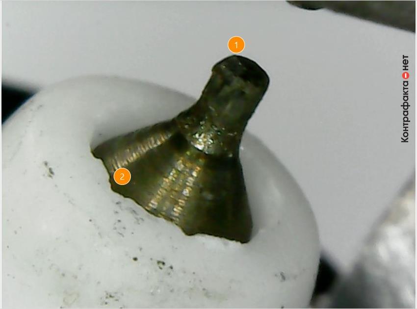 1. Иридиевый наконечник заменен железоникелевым. | 2. Колотые края теплового конуса изолятора.